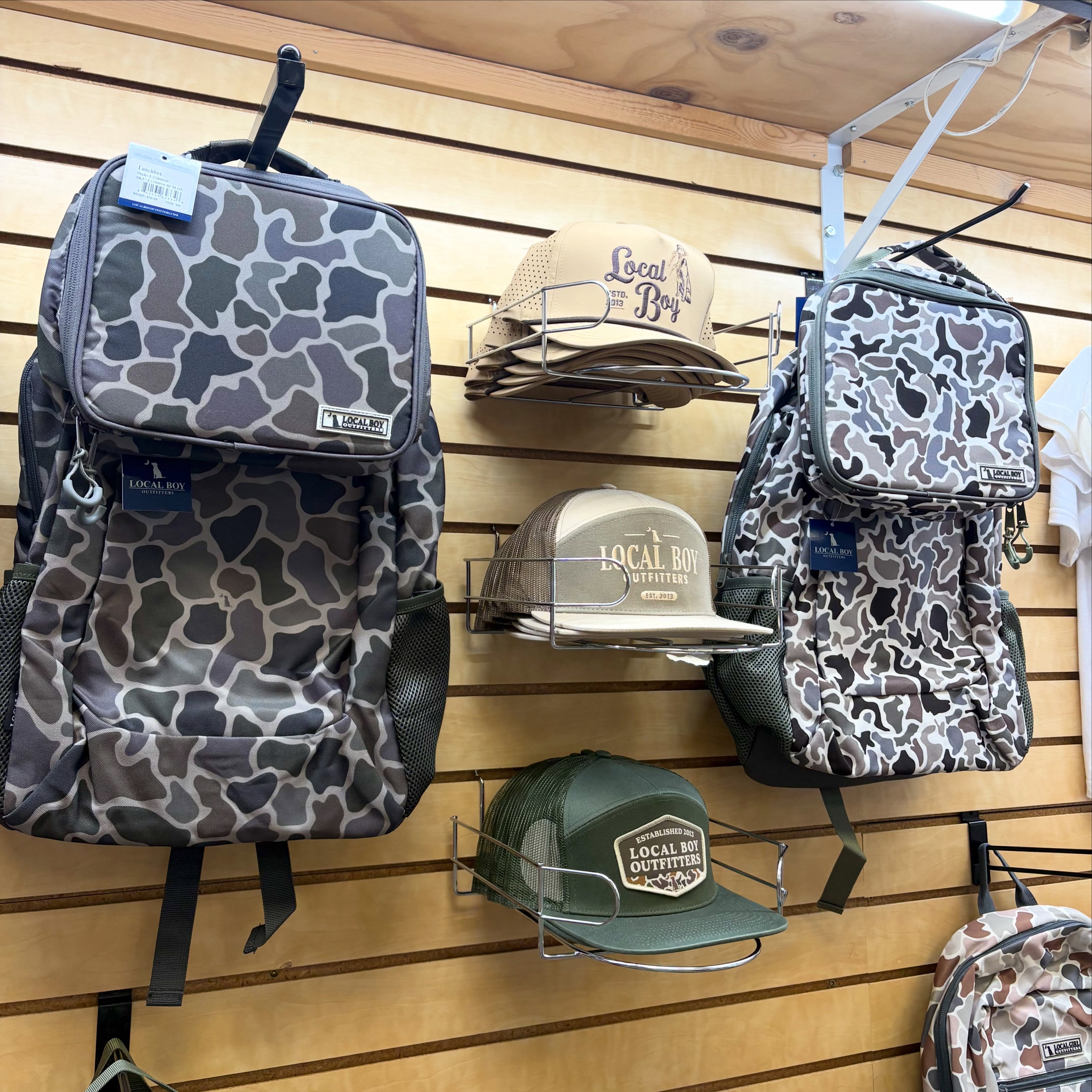 Local Boy Outfitters camouflage school backpacks lunch bag and hats displayed at Reeves Clayton Georgia