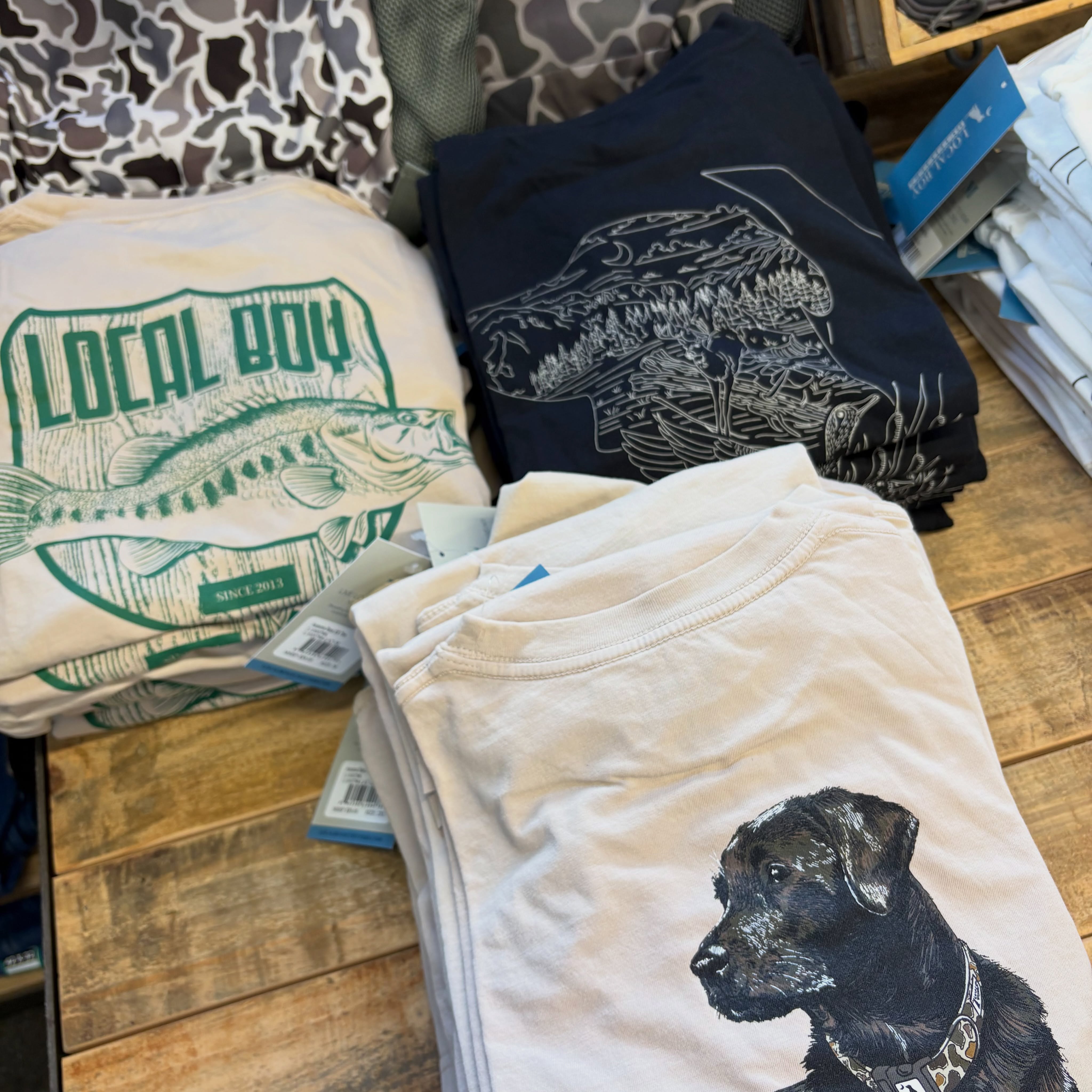 Local Boy Outfitters graphic shirts with fishing outdoor and dog designs at Reeves in Clayton GA