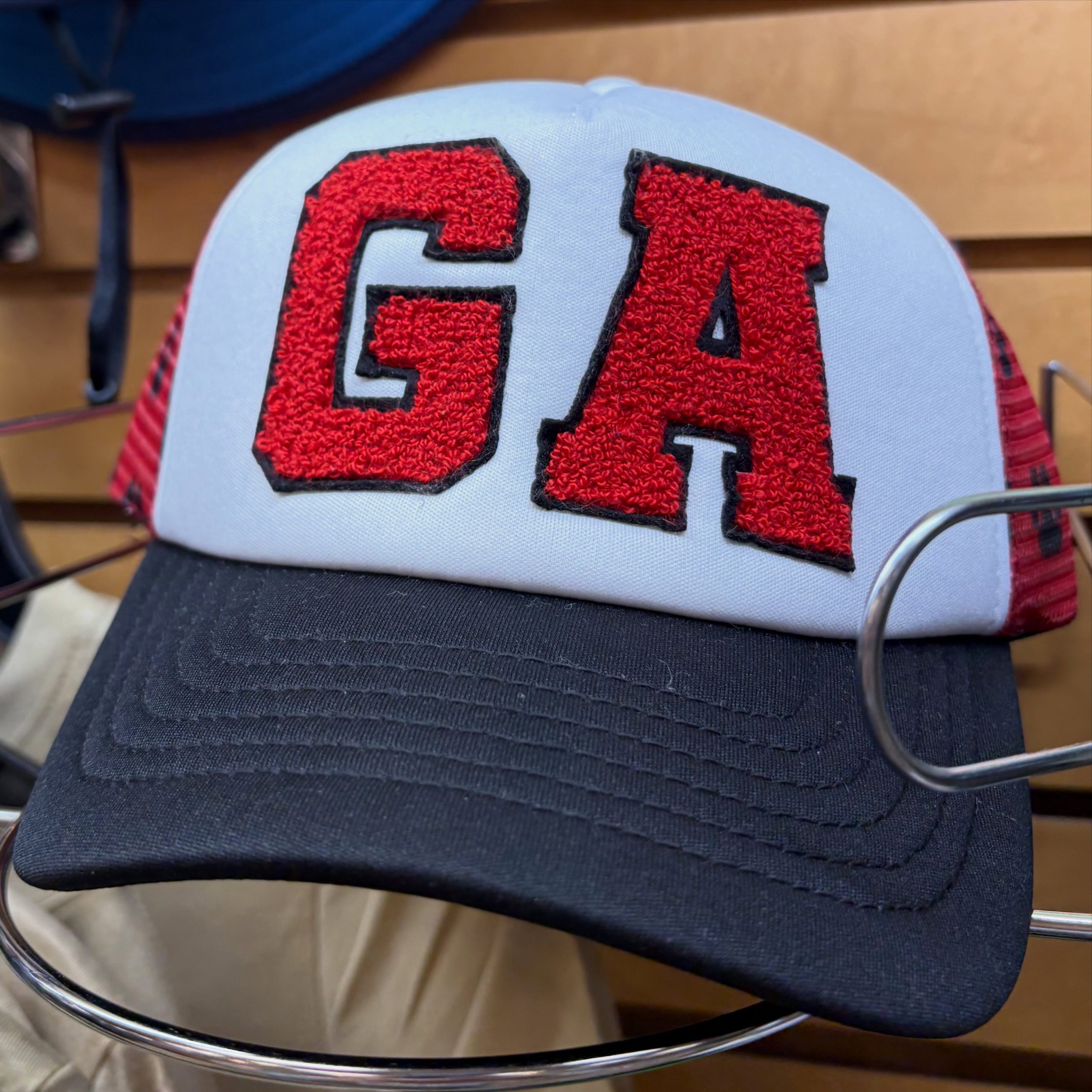 Close-up of a light gray baseball cap with red embroidered number 94.